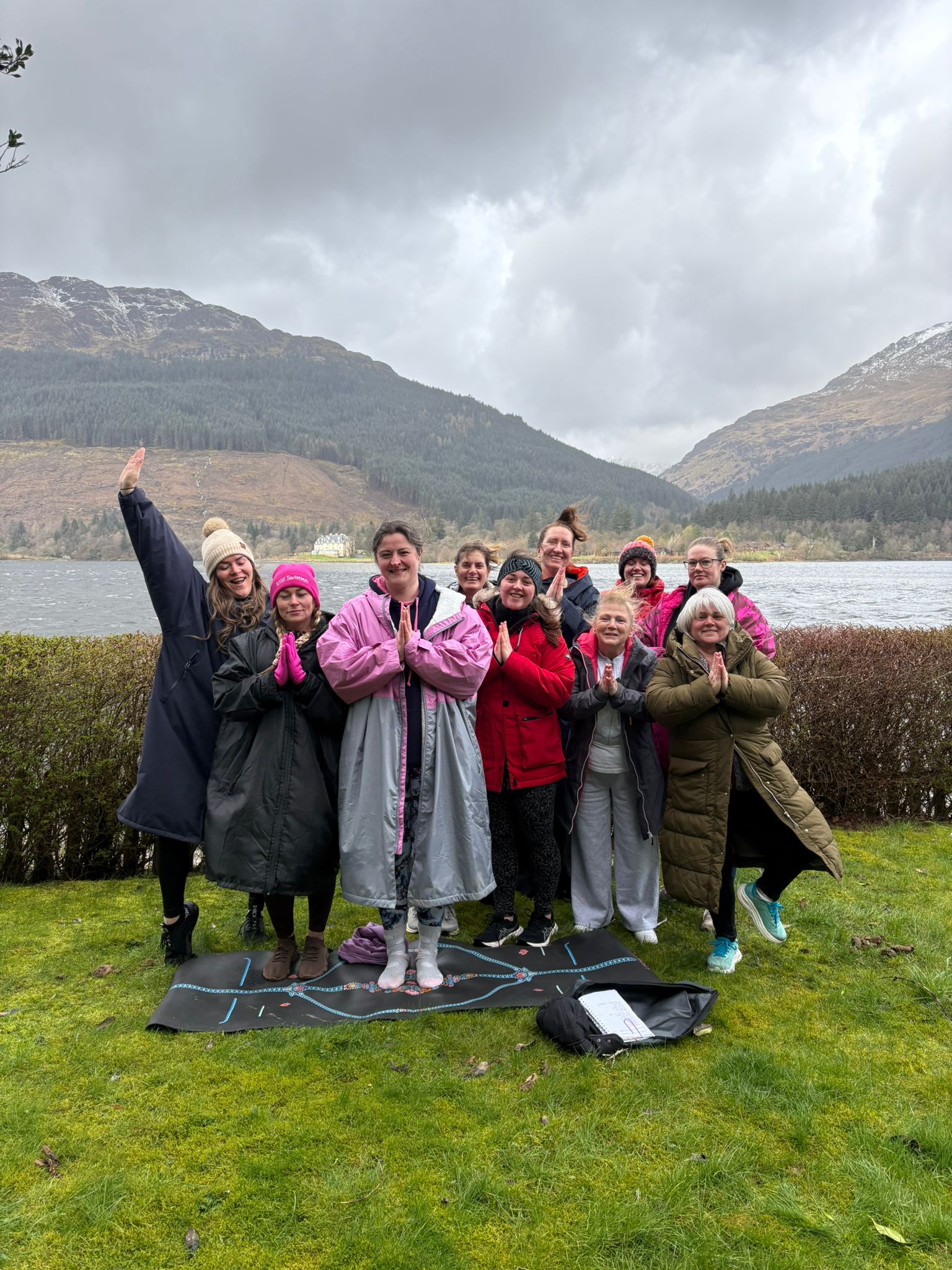 Outdoor yoga group by the loch